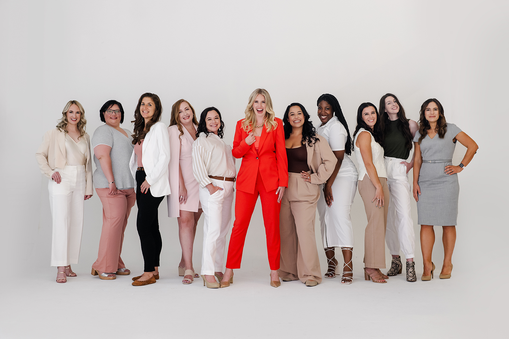 Women in business suits standing together proudly